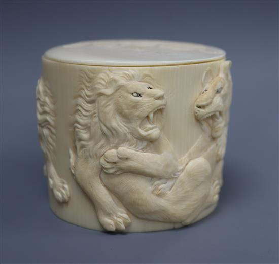 A carved ivory box decorated with tigers fighting lions